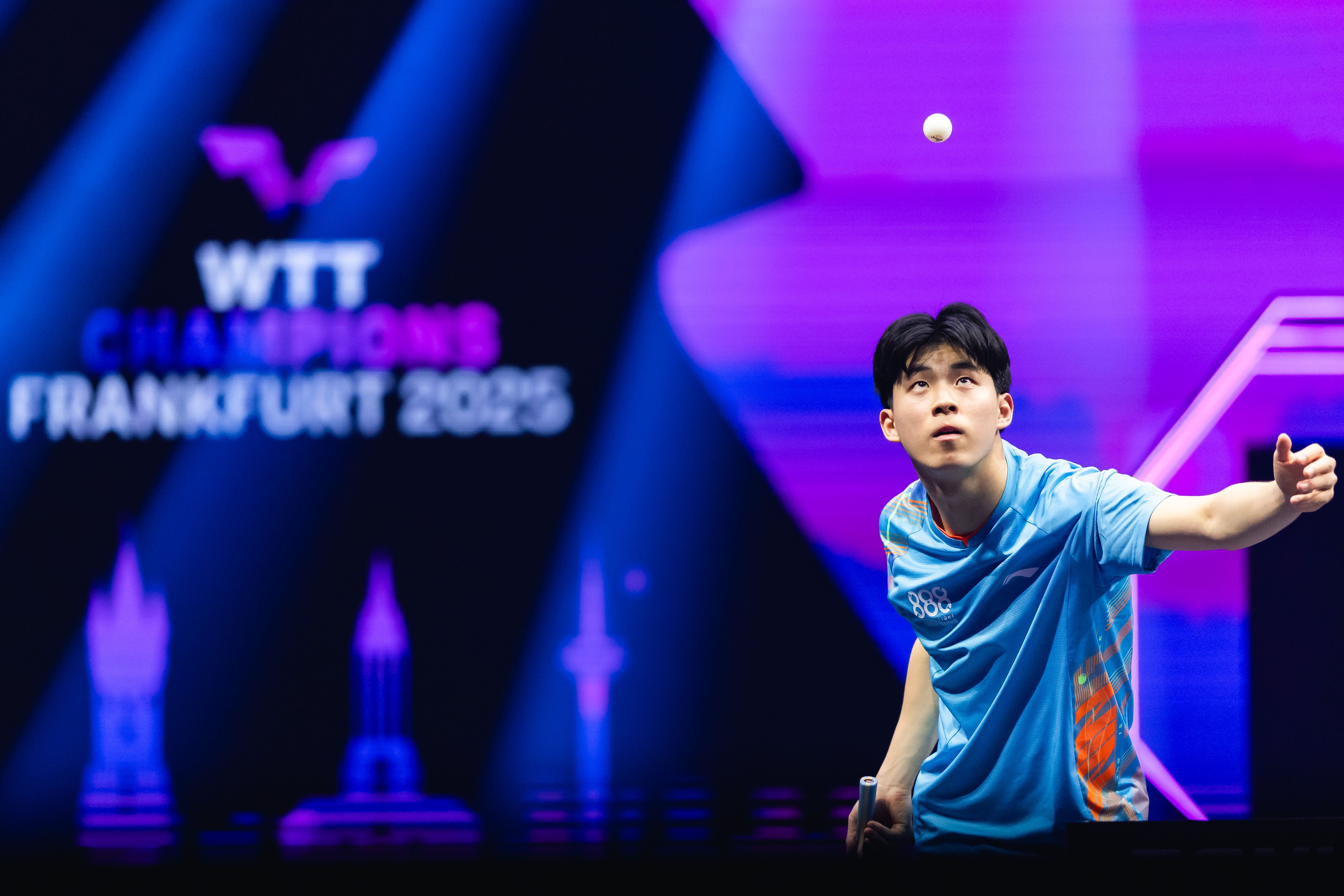 Hwan Bae mid-serve, gazing up at the ball, WTT Champions Frankfurt 2025